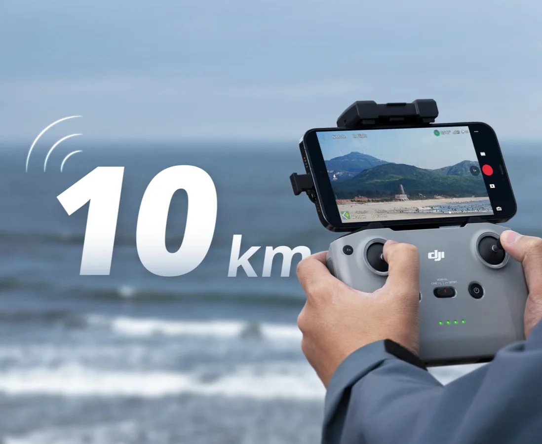 Pilot watching the live 10 km video feed on a phone-mounted controller